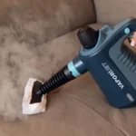 Ръчният парочистач Парен пистолет VAPORÌ JET се използва за почистване на диван от плат с пара.